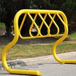 public outdoor bike parking rack in a bright color is located in a park