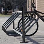 the public bike racks for parking is in service outside the apartment building