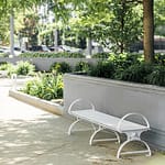 custom metal park benches lay quietly in the street park creating a beautiful drawing with the park landscaping. The bench is a great option for metro and public transit station applications