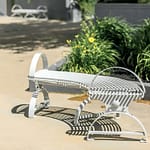 metal curve outdoor benches/ metro and park benches personalized in bright silver-white highlighted themselves in the beautiful green and yellow background environment