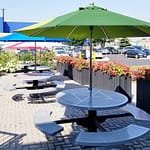 steel outdoor commercial garden picnic tables installed outside IKEA embraced by pretty flowers