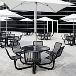 Metal patio outdoor picnic tables with patio umbrellas create a place for employees and customers to relax and share some time and food together