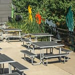 10 square outdoor recycled plastic patio picnic tables are in service at the community center for outdoor dining