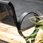 outdoor commercial metal memorial and commemorative park bench on the street