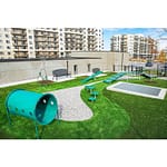 2 classic metal benches are by the kid's playground in a apartment community