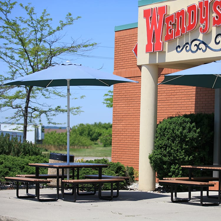 picnic tables outdoor picnic table for patio with patio umbrellas are chosen by Wendy's to provide a space for their customers to enjoy their food in the open air
